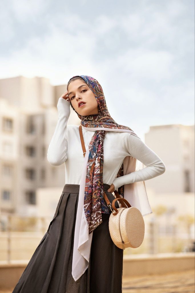 A woman creating a statement look with layered headscarves