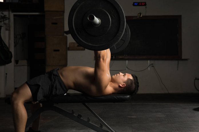 Shirtless man in a bench press Bench Press Set